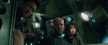 Movie still from “Meg 2: The Trench” (2023), directed by Ben Wheatley – A group of people standing in a room with lights; Close Up shot, Low angle