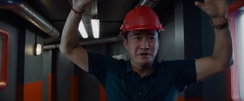 Movie still from “Meg 2: The Trench” (2023), directed by Ben Wheatley – A man wearing a red hard hat in an industrial setting; Close Up shot, Low angle