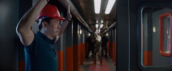 Movie still from “Meg 2: The Trench” (2023), directed by Ben Wheatley – A group of people standing in a hallway; Medium shot, Over the shoulder angle