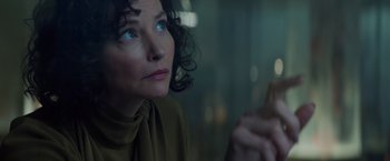 Movie still from “Meg 2: The Trench” (2023), directed by Ben Wheatley – A person sitting in front of a window; Close Up shot, Low angle