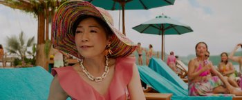 Movie still from “Meg 2: The Trench” (2023), directed by Ben Wheatley – A woman wearing a pink dress and a pink hat; Close Up shot, High angle