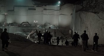 Movie still from “Memories of Murder” (2003), directed by Bong Joon Ho – A group of people standing around in an abandoned building; Extreme Wide shot, High angle
