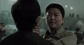 Movie still from “Memories of Murder” (2003), directed by Bong Joon Ho – A man is looking into the reflection of himself in a mirror; Close Up shot, Over the shoulder angle