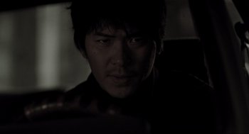 Movie still from “Memories of Murder” (2003), directed by Bong Joon Ho – A person wearing a black shirt; Close Up shot, Low angle