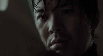 Movie still from “Memories of Murder” (2003), directed by Bong Joon Ho – A person's face with water droplets on them; Extreme Close Up shot, Low angle