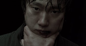 Movie still from “Memories of Murder” (2003), directed by Bong Joon Ho – A person with blood on his face; Extreme Close Up shot, Low angle