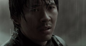 Movie still from “Memories of Murder” (2003), directed by Bong Joon Ho – A man's face in the pouring rain; Close Up shot, Low angle