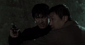 Movie still from “Memories of Murder” (2003), directed by Bong Joon Ho – Two asian men are fighting in the dark; Close Up shot, Over the shoulder angle