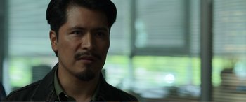 Movie still from “Memory” (2022), directed by Martin Campbell – A person with a beard; Close Up shot, Over the shoulder angle