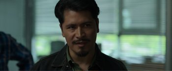 Movie still from “Memory” (2022), directed by Martin Campbell – A person wearing a jacket; Close Up shot, Over the shoulder angle