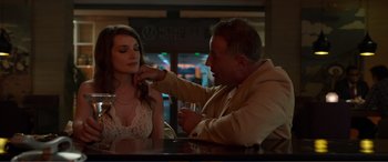 Movie still from “Memory” (2022), directed by Martin Campbell – A man and a woman sitting at a table; Close Up shot, Low angle