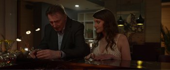 Movie still from “Memory” (2022), directed by Martin Campbell – A man and a woman sitting at a table; Close Up shot, Over the shoulder angle