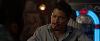 Movie still from “Memory” (2022), directed by Martin Campbell – A person wearing a shirt; Close Up shot, Over the shoulder angle