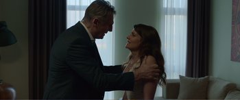 Movie still from “Memory” (2022), directed by Martin Campbell – A man and a woman are standing together; Close Up shot, Low angle