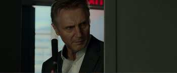 Movie still from “Memory” (2022), directed by Martin Campbell – Liam neeson holding a gun; Close Up shot, Over the shoulder angle