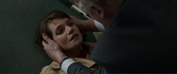 Movie still from “Memory” (2022), directed by Martin Campbell – A man touching the neck of a woman with her hands; Close Up shot, Over the shoulder angle