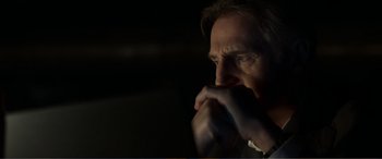 Movie still from “Memory” (2022), directed by Martin Campbell – A person with his hand to his face; Close Up shot, Low angle