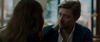 Movie still from “Memory” (2022), directed by Martin Campbell – A man and a woman sitting at a table; Close Up shot, Over the shoulder angle