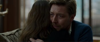 Movie still from “Memory” (2022), directed by Martin Campbell – A person hugging another person; Close Up shot, Over the shoulder angle