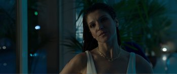 Movie still from “Memory” (2022), directed by Martin Campbell – A person wearing a necklace; Close Up shot, Low angle