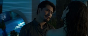 Movie still from “Memory” (2022), directed by Martin Campbell – A person wearing a black shirt; Close Up shot, Over the shoulder angle