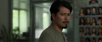 Movie still from “Memory” (2022), directed by Martin Campbell – A person with a beard; Close Up shot, Over the shoulder angle