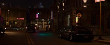 Movie still from “Memory” (2022), directed by Martin Campbell – Cars parked on the side of the street at night; Extreme Wide shot, High angle