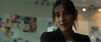 Movie still from “Memory” (2022), directed by Martin Campbell – A person wearing a suit; Close Up shot, Over the shoulder angle