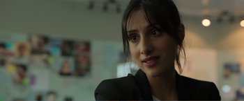 Movie still from “Memory” (2022), directed by Martin Campbell – A person wearing a suit; Close Up shot, Over the shoulder angle