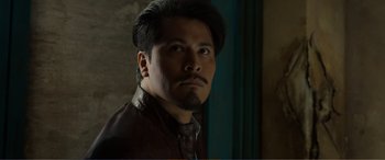 Movie still from “Memory” (2022), directed by Martin Campbell – A person wearing a leather jacket; Close Up shot, Low angle