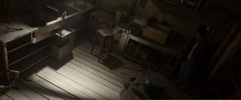 Movie still from “Memory” (2022), directed by Martin Campbell – A kitchen with a wooden floor and a stove; Extreme Wide shot, High angle