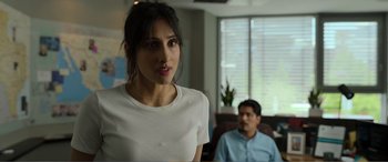 Movie still from “Memory” (2022), directed by Martin Campbell – A woman standing in front of a man in a room; Close Up shot, Over the shoulder angle