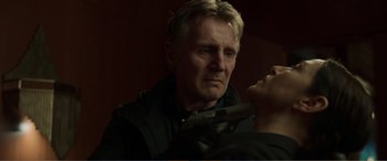 Movie still from “Memory” (2022), directed by Martin Campbell – A person holding a knife; Close Up shot, Low angle