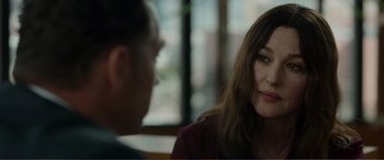 Movie still from “Memory” (2022), directed by Martin Campbell – A woman and a man are sitting at a table; Close Up shot, Over the shoulder angle