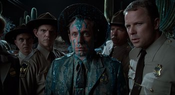 Movie still from “Men in Black” (1997), directed by Barry Sonnenfeld – A group of men standing next to each other; Medium shot, Over the shoulder angle