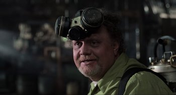Movie still from “Men in Black” (1997), directed by Barry Sonnenfeld – A man with a gas mask on his head; Close Up shot, Low angle