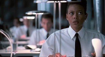 Movie still from “Men in Black” (1997), directed by Barry Sonnenfeld – A man and a woman in white shirts and black ties; Close Up shot, Low angle