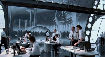 Movie still from “Men in Black” (1997), directed by Barry Sonnenfeld – A group of people sitting at tables in a room; Wide shot, Low angle