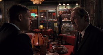 Movie still from “Men in Black 3” (2012), directed by Barry Sonnenfeld – Two people sitting at a table in a restaurant; Medium shot, Over the shoulder angle