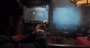 Movie still from “Men in Black 3” (2012), directed by Barry Sonnenfeld – A man in a suit holding a cell phone in his hand; Medium shot, Over the shoulder angle