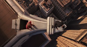 Movie still from “Men in Black 3” (2012), directed by Barry Sonnenfeld – A man and a woman are on a slide in a city; Extreme Wide shot, Overhead angle