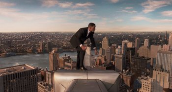 Movie still from “Men in Black 3” (2012), directed by Barry Sonnenfeld – A man standing on top of a building on top of a building; Wide shot, High angle