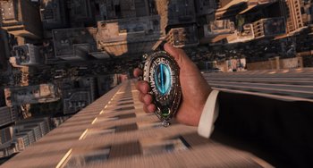 Movie still from “Men in Black 3” (2012), directed by Barry Sonnenfeld – A hand holding a pocket watch with a picture of an eye; Extreme Close Up shot, Overhead angle