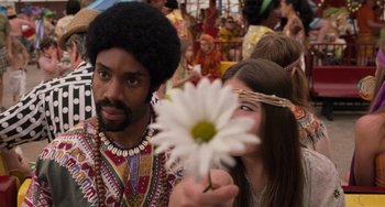 Movie still from “Men in Black 3” (2012), directed by Barry Sonnenfeld – A man and a woman holding up a white flower; Close Up shot, Over the shoulder angle
