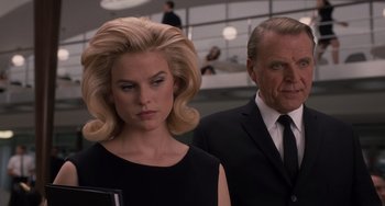 Movie still from “Men in Black 3” (2012), directed by Barry Sonnenfeld – A man and a woman standing next to each other in a room; Close Up shot, Low angle
