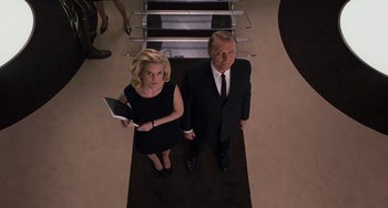 Movie still from “Men in Black 3” (2012), directed by Barry Sonnenfeld – A man and a woman standing next to each other in a room; Medium shot, Low angle