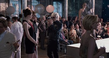 Movie still from “Men in Black 3” (2012), directed by Barry Sonnenfeld – A man taking a picture of a crowd of people; Wide shot, Over the shoulder angle