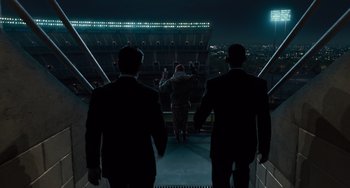 Movie still from “Men in Black 3” (2012), directed by Barry Sonnenfeld – A group of men walking up a flight of stairs at night; Extreme Wide shot, Low angle
