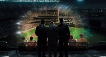 Movie still from “Men in Black 3” (2012), directed by Barry Sonnenfeld – A group of men standing in front of a baseball field; Extreme Wide shot, High angle