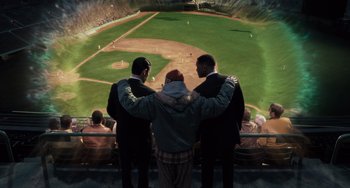 Movie still from “Men in Black 3” (2012), directed by Barry Sonnenfeld – A group of men standing next to each other at a baseball field; Wide shot, High angle